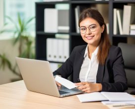 smiling-woman-sitting-desk_compressed (1)